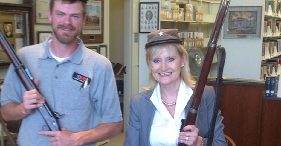Cindy Hyde-Smith, posing with Confederate artifacts