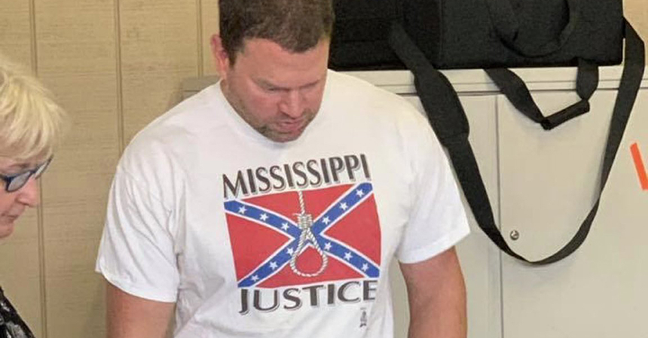 Clayton Hickey voting while wearing his "Mississippi justice" shirt